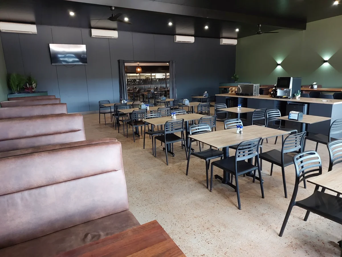 Refurbished dining room at Oasis at Newman mining village showcasing durable Compact Laminate tables, stackable dining chairs and custom booth seating.