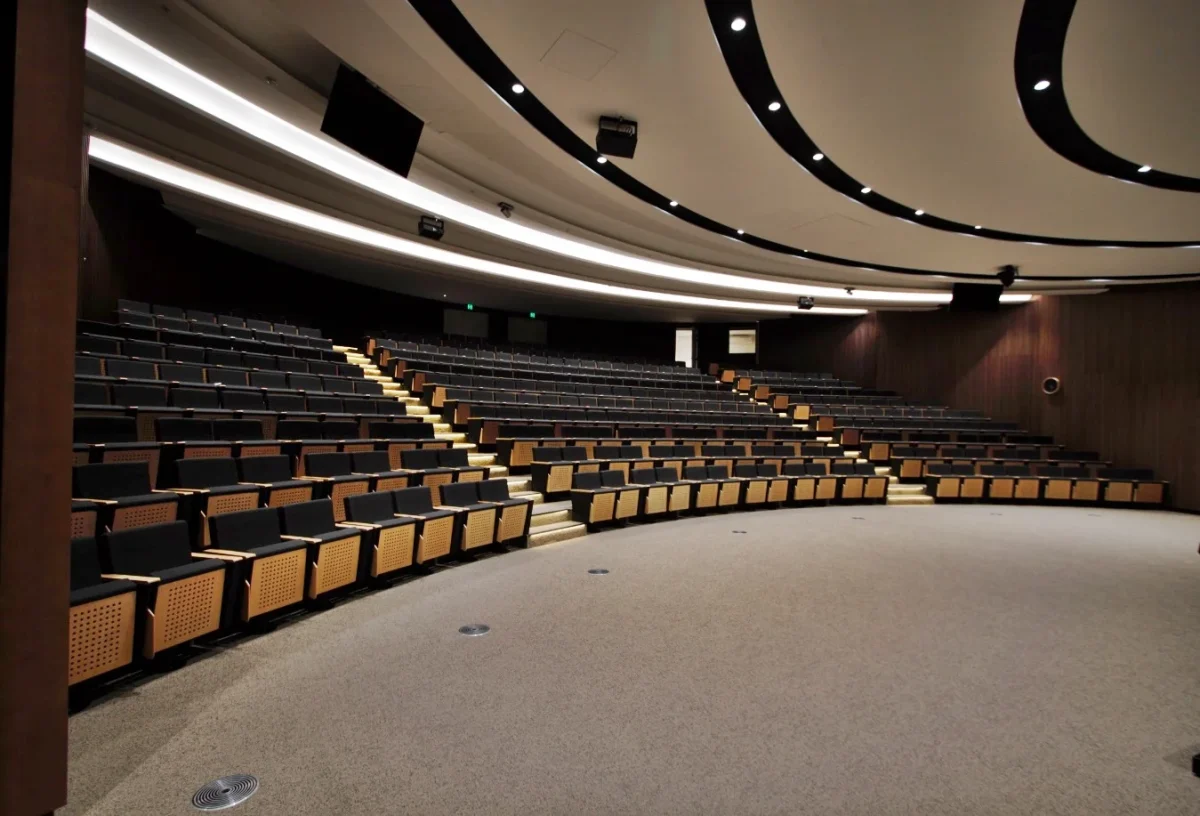 Commercial auditorium seating installation for Woodside Energy featuring tiered fixed seating and integrated lighting at a corporate auditorium in Western Australia