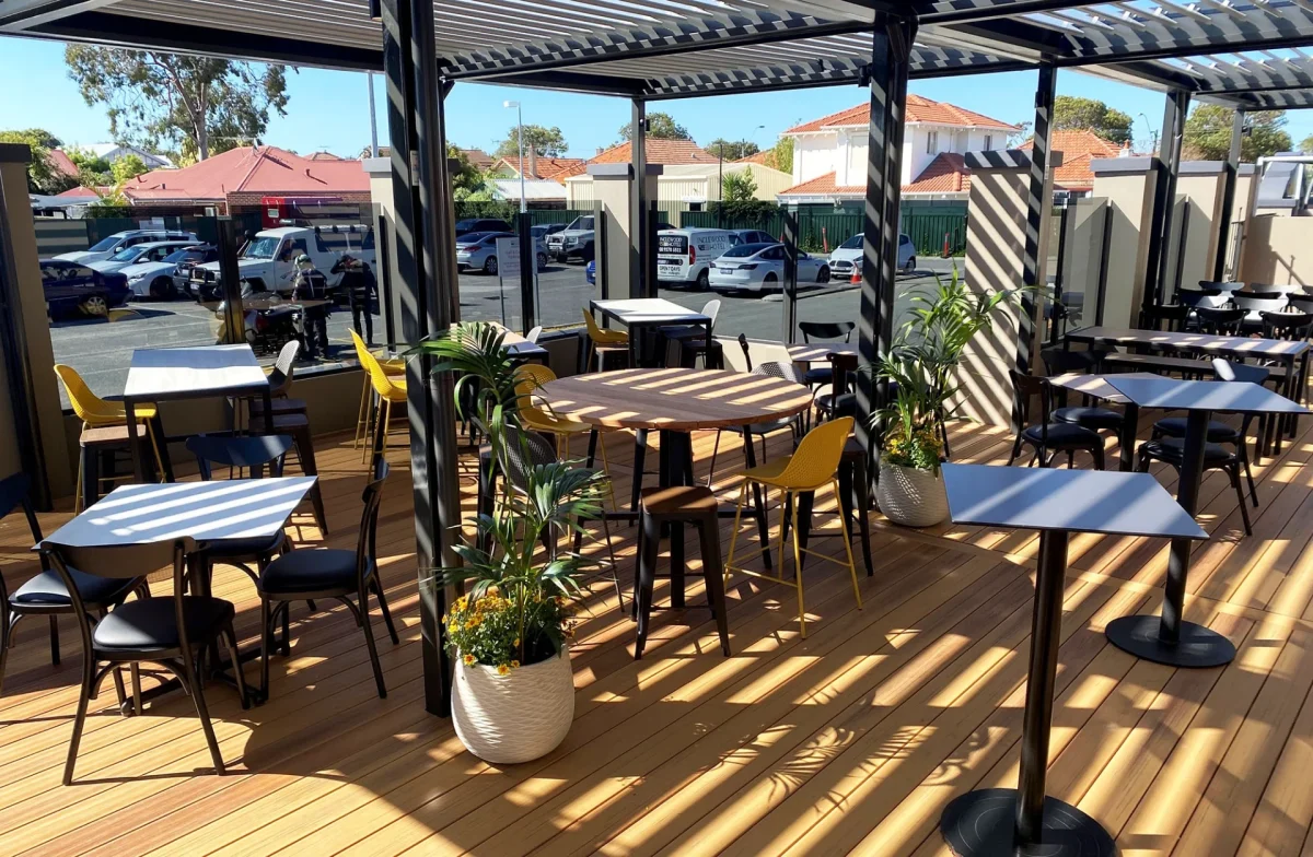 Inglewood Hotel outdoor area featuring round and rectangular alfresco tables, durable outdoor seating and vibrant planters to complete the commercial fit-out.