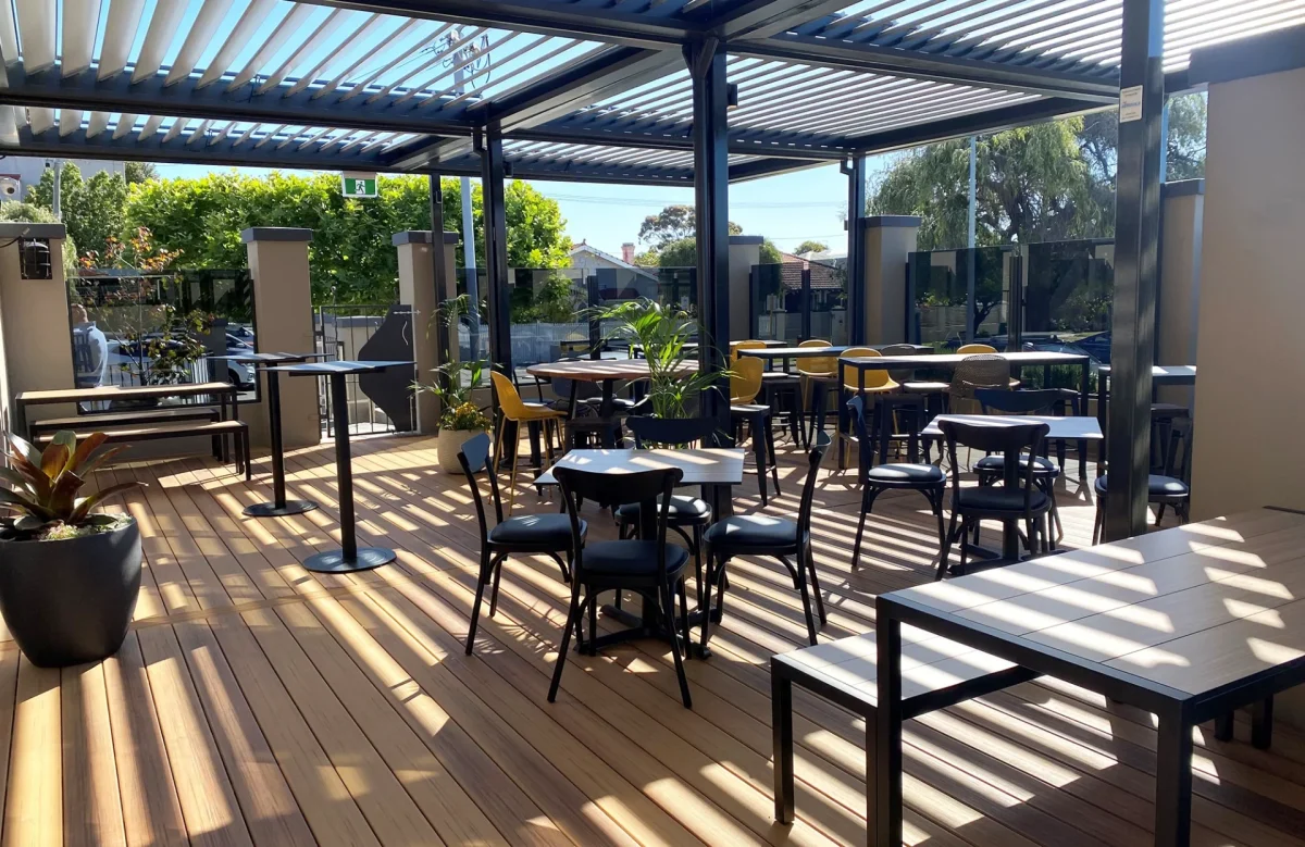 Outdoor deck at the Inglewood Hotel showcasing Compact Laminate dining tables, high bars and a mix of Bistro Chairs and outdoor barstools.