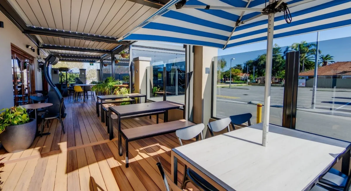 Alfresco dining space at the Inglewood Hotel fitted with long Compact Laminate tables, outdoor benches and a variety of commercial seating options.
